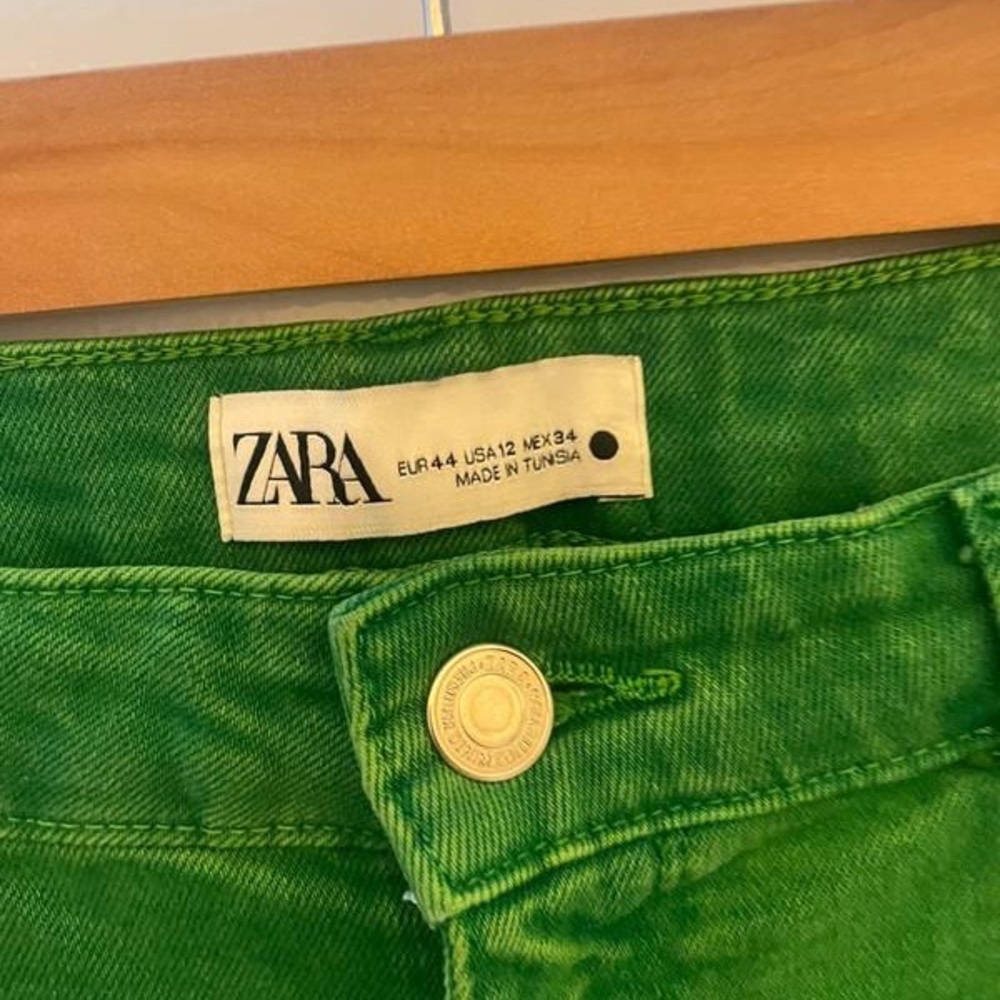 Green raw edge flared jeans